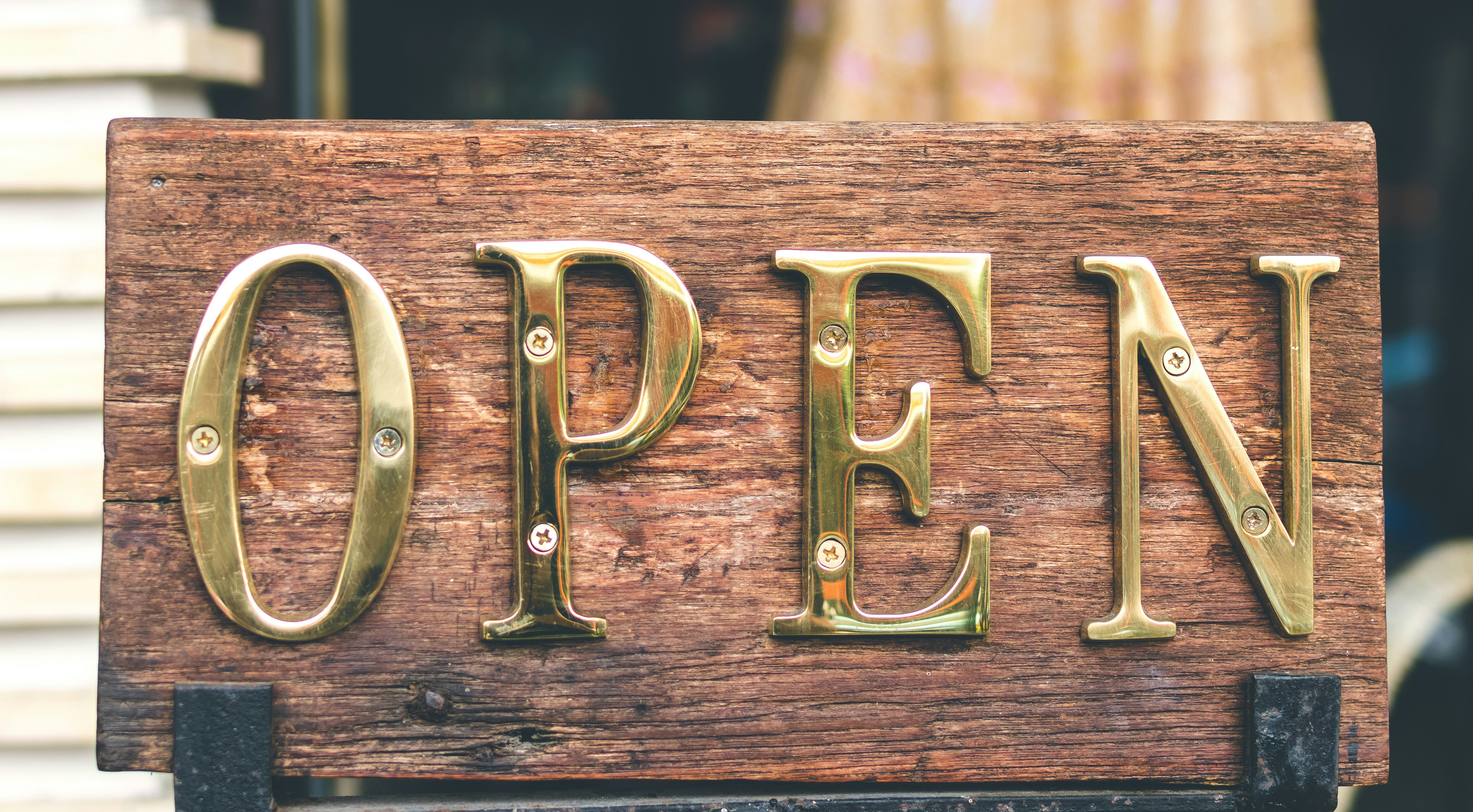 Bronze lettering on a wooden placard